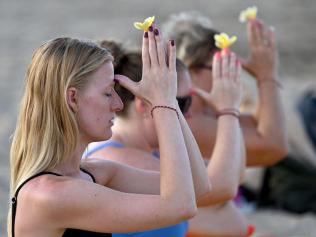 Foreign tourists participate in a Balinese Hindu prayer gathering on a beach in Seminyak near Denpasar on Indonesia's resort island of Bali on August 5, 2023. Picture: SONNY TUMBELAKA/AFP