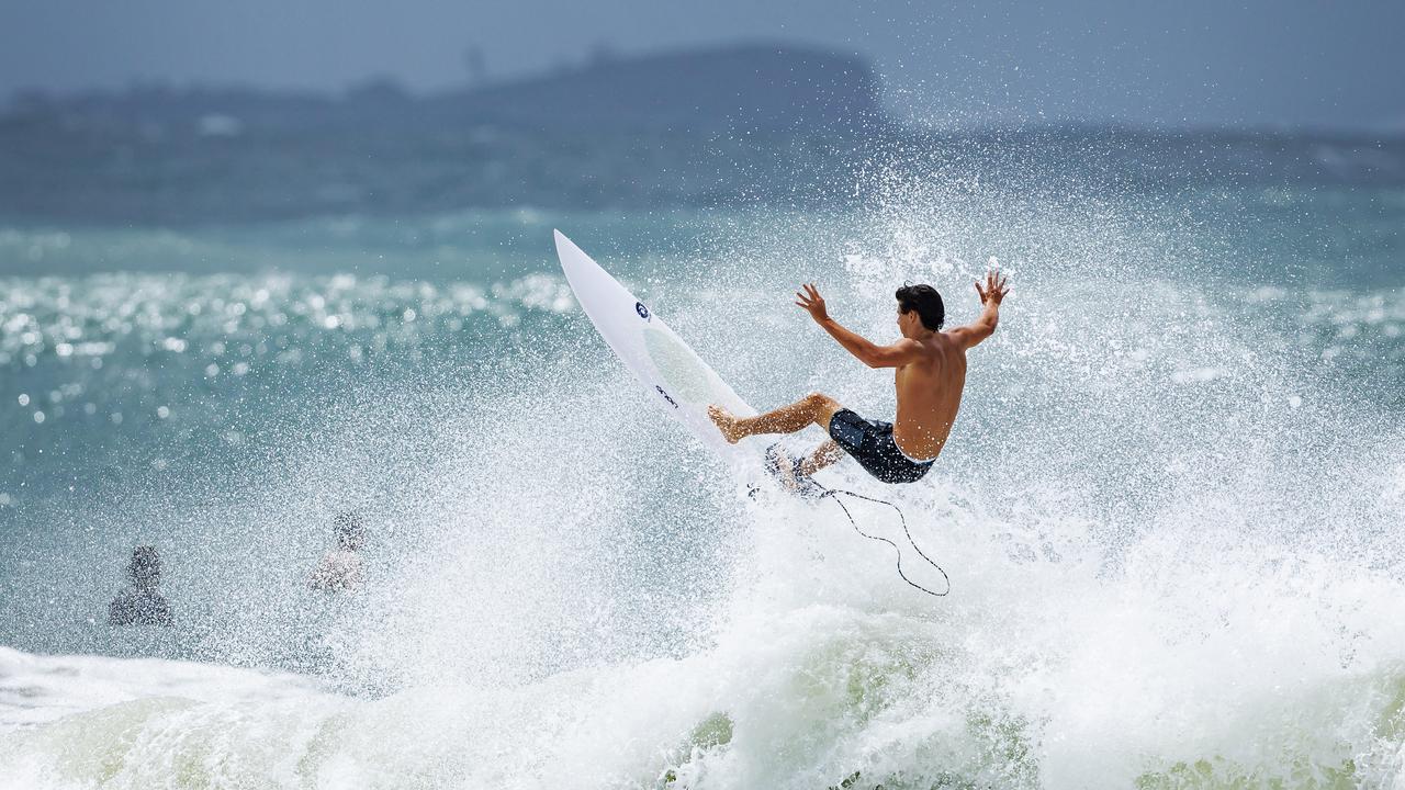 A surfer flies as big swell hit Mooloolaba on Sunday. Picture: Lachie Millard