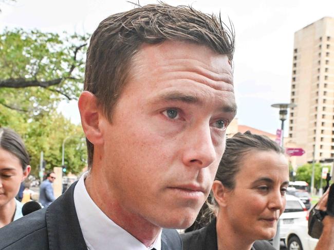 ADELAIDE, AUSTRALIA - NewsWire Photos, MARCH 13, 2024:  Cyclist Rohan Dennis, centre, leaves the Adelaide Magistrates Court where he is facing charges over the death of his wife Melissa Hoskins. Picture: NCA NewsWire / Brenton Edwards