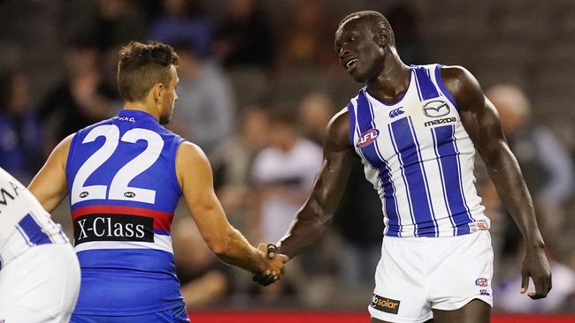 Bundoora recruit Sam Lloyd and North Heidelberg recruit Majak Daw shake the hand.