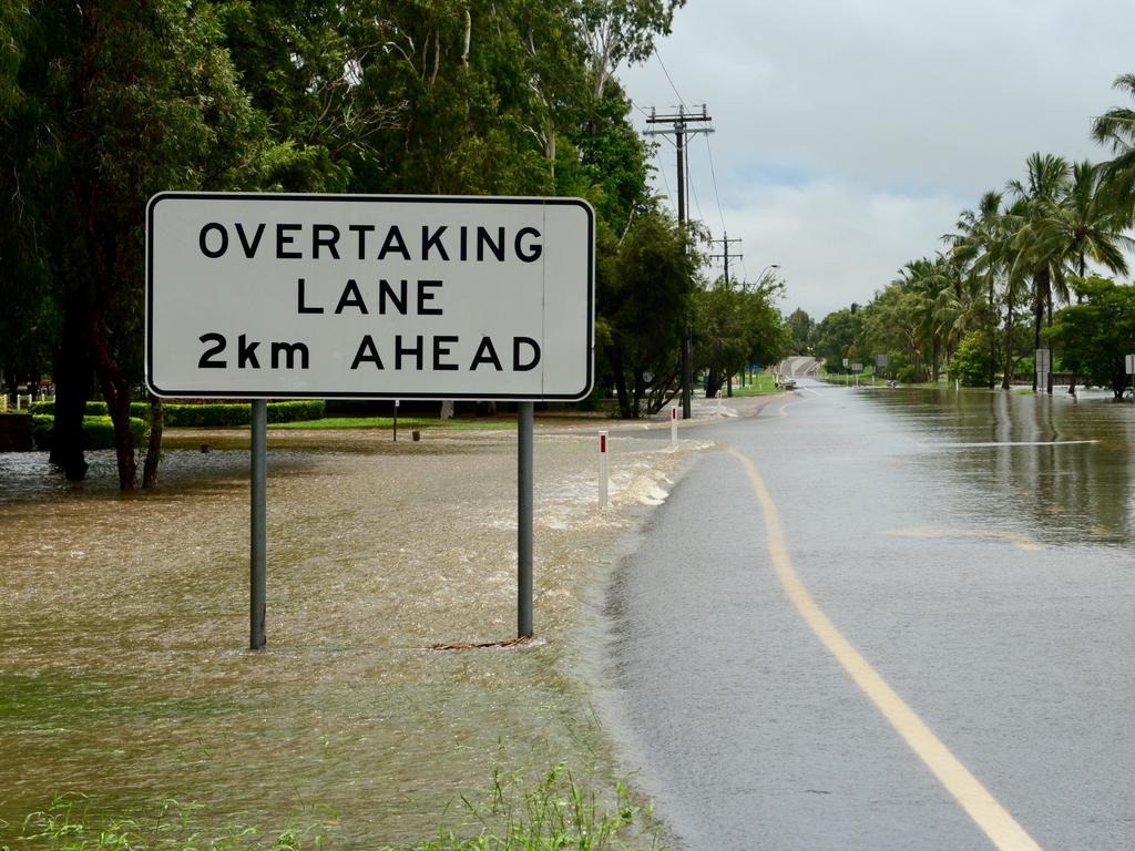 Water over the road and no traffic on the Bruce Highway at Plantation Creek in Ayr. Picture: Scott Radford-Chisholm