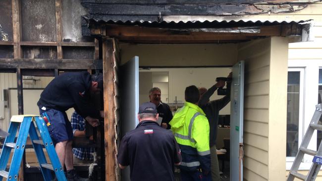 Workers repairing damage caused by an overnight fire at the old Lindisfarne North Primary School. Picture: MATT THOMPSON