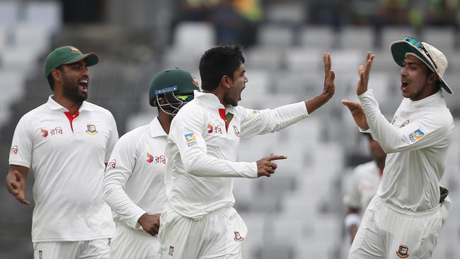 Bangladesh's Mehedi Hasan, second right, celebrates Steve Smith’s wicket.