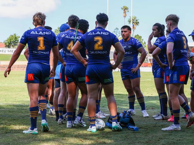 Tyrese Lokeni in a shell-shocked Parramatta team huddle following another Bulldogs try. Picture: Adam Wrightson Photography.