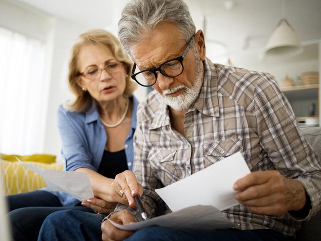 Shot of a senior couple looking stressed while going over their finances at home; wealth superannuation worries generic bills