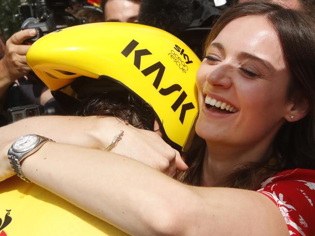 Sarah Elen hugs her husband Britain's Geraint Thomas, wearing the overall leader's yellow jersey, after the twentieth stage of the Tour de France cycling race.