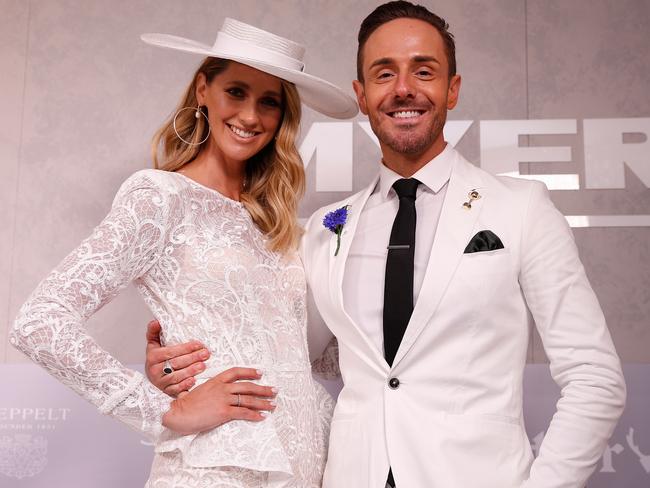 Nikki Phillips and Donny Galella pose at the Myer Fashion on the Field marquee. Picture: Daniel Pockett, Getty Images.