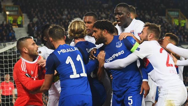 Ashley Williams of Everton (5) clashes with Lyon players after a challenge on Anthony Lopes.