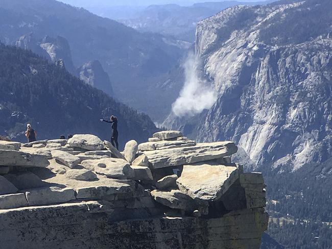 A cloud of dust is seen in the distance on El Capitan after a major rock fall in Yosemite National Park, Calif.  Picture: John P. DeGrazio/YExplore Yosemite Adventures via AP