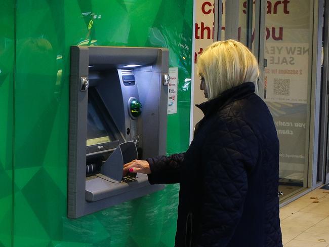 SYDNEY, AUSTRALIA - NewsWire Photos -FEBRUARY 22 2022: Pedestrians are seen walking past an ATM machine in Sydney. Picture: NCA Newswire / Gaye Gerard