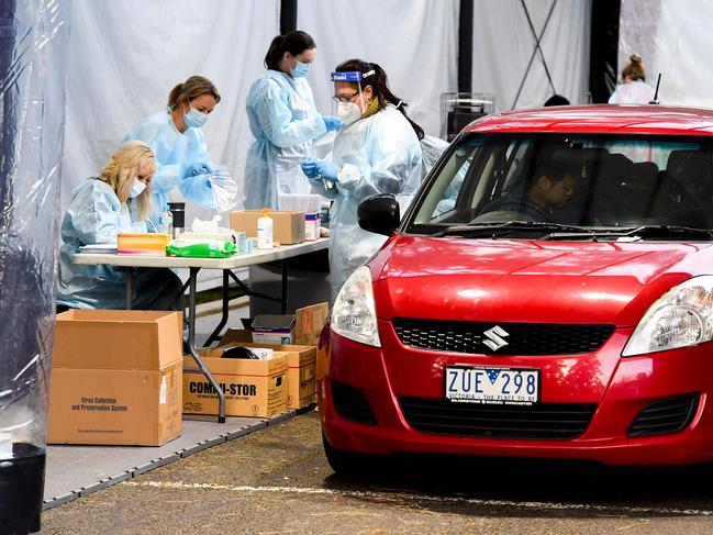 Medical staff perform COVID-19 coronavirus tests at a drive-through facility in Melbourne yesterday. Picture: AFP