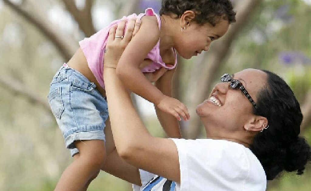 Kate Gumaka with her two-year-old daughter Keilani Lelo enjoy the Jacaranda Festival at Goodna on Saturday. . Picture: Sarah Harvey