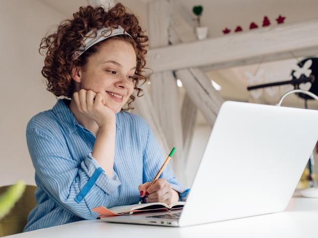 SMARTDAILY: Young woman working from her home office.