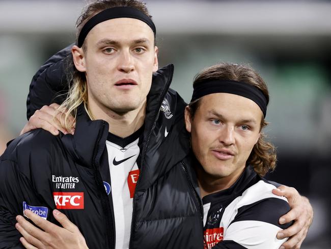 MELBOURNE, AUSTRALIA - AUGUST 11: Jack Ginnivan of the Magpies shares an embrace with Darcy Moore of the Magpies as Moore is subbed out of the game during the round 22 AFL match between Collingwood Magpies and Geelong Cats at Melbourne Cricket Ground, on August 11, 2023, in Melbourne, Australia. (Photo by Darrian Traynor/Getty Images)