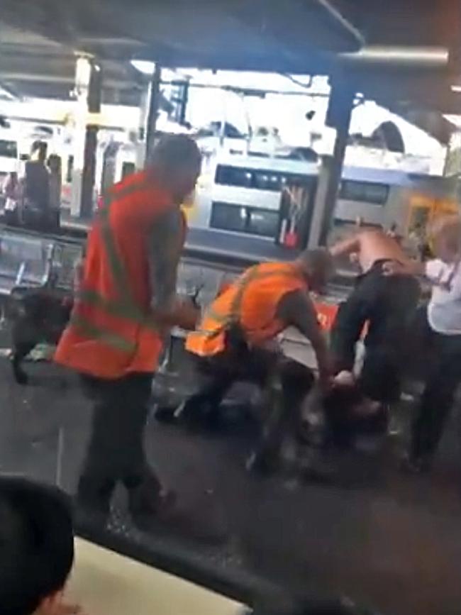 Several staff members gathered around the scuffle. Picture: Seven News