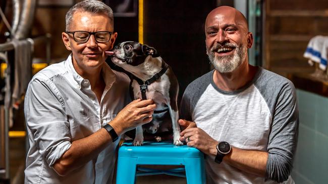 Shawn Burgess and Greg Horner with their dog Samuel Adams, a five-year-old Boston terrier. Picture: Monique Harmer.