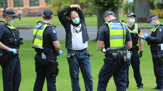 Police spoke to several maskless protesters. Picture: Alex Coppel.