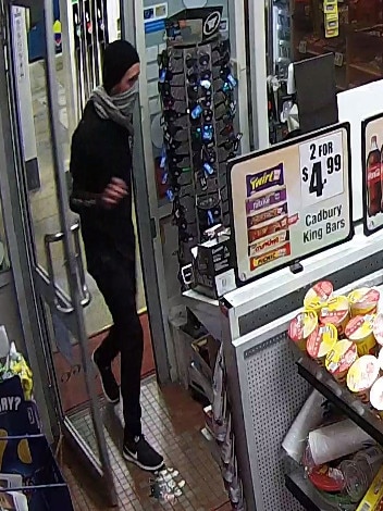 CCTV image of a robber armed with a kitchen knife entering a servo in Freshwater. Source: NSW Police