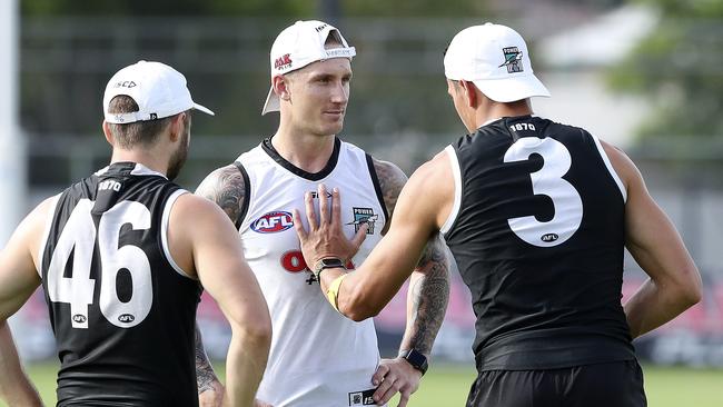 Hartlett chats with Ryan Burton and Sam Gray after returning to full team training in February. Picture Sarah Reed