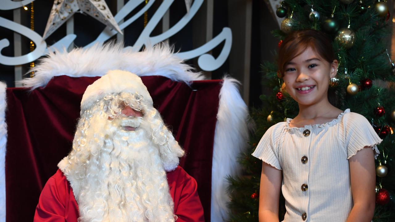 Olivia Crompton, 10, receives a gift from Santa at Silks, Darwin. Picture: (A)manda Parkinson