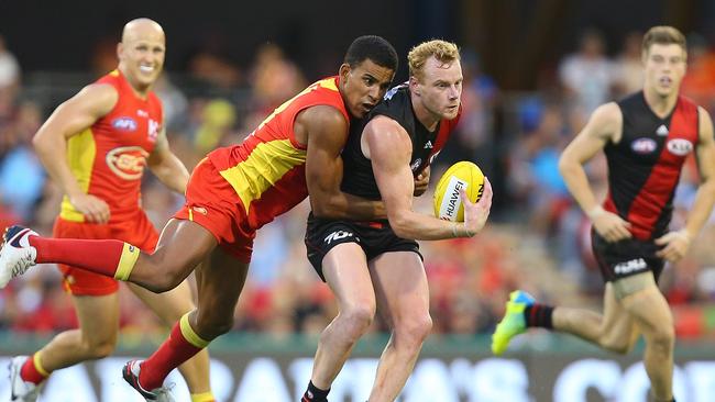 Adam Cooney under pressure from Touk Miller. Picture: Getty