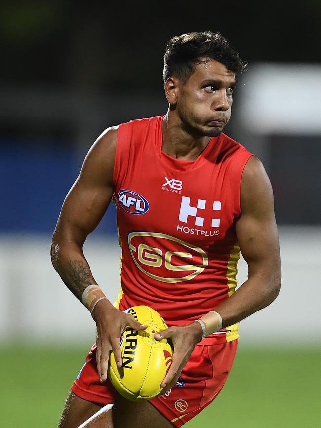 MACKAY, AUSTRALIA - MARCH 03: Callum Ah Chee of the Suns runs the ball during the 2019 JLT Community Series AFL match between the Gold Coast Suns and the Western Bulldogs at Great Barrier Reef Arena on March 03, 2019 in Mackay, Australia. (Photo by Ian Hitchcock/Getty Images)