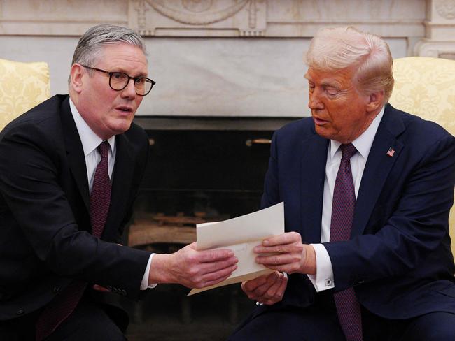 US President Donald Trump holds a letter from Britain's King Charles III during a meeting with British Prime Minister Keir Starmer in the Oval Office of the White House. Picture: AFP