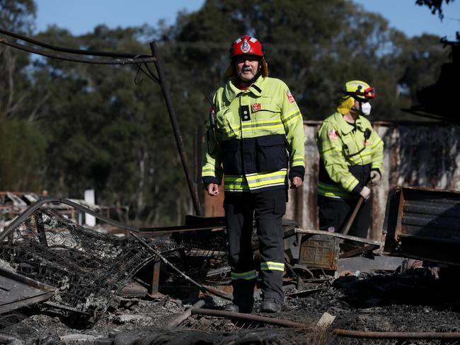 Station officer Jamie Towle and fellow firefighters at the charred old Adventureland theme park on Camden Valley Way. Picture: Jane Dempster