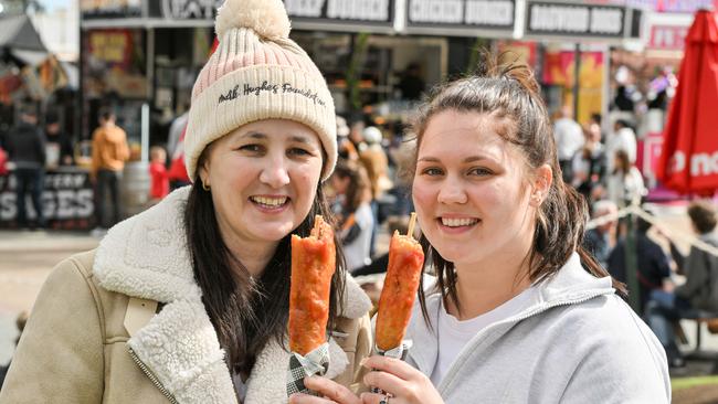 Melissa and Britney Shorter waited all year for a Dagwood dog. Picture: Brenton Edwards