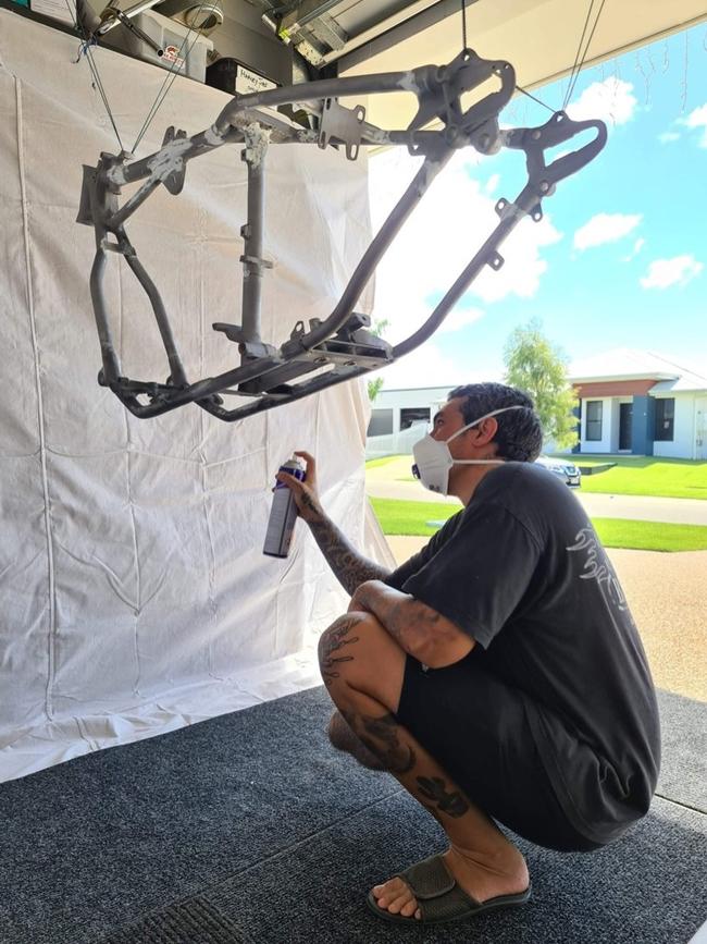 Townsville army veteran Adam Barrett during the process of rebuilding his Harley chopper.