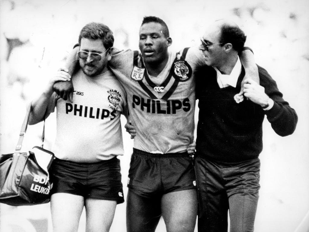 Balmain star Ellery Hanley is assisted from field during 1998 grand final against Canterbury.