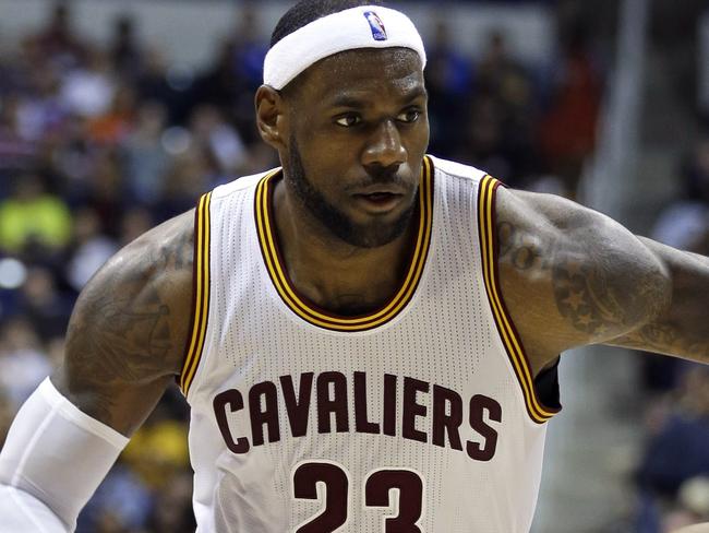 Cleveland Cavaliers forward LeBron James (23) drives past Indiana Pacers guard George Hill (3) in the second half of an NBA preseason basketball game, Wednesday, Oct. 15, 2014, in Cincinnati. Cleveland won 98-93. (AP Photo/Al Behrman)