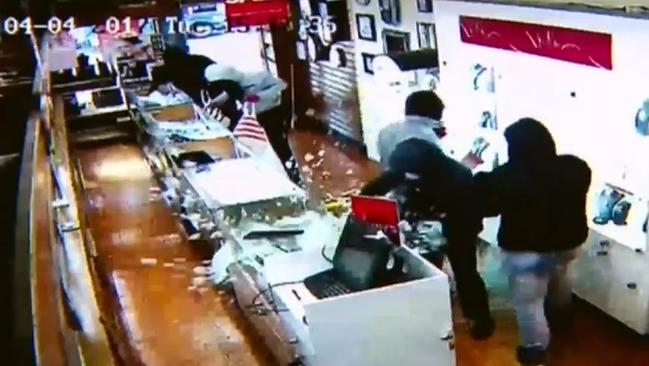 The robber smashes the counter glass to take the jewellery. Picture: Channel 9.
