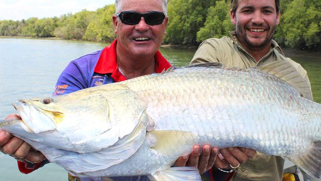 Allan Beale of Darwin’s Barra Base Fishing Safaris (left) helps David Boon with the metre Finniss River barra that four anglers took turns fighting before it was landed