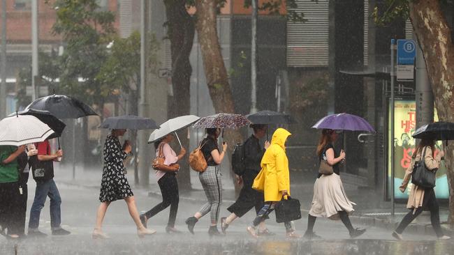 Commuters dusted off the umbrellas in Sydney’s CBD. Picture: John Grainger