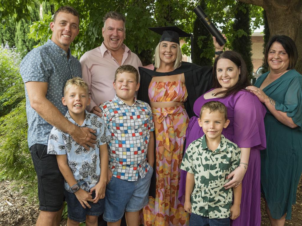 Bachelor of Early Childhood graduate Tiffany MacDonald celebrates with family (front, from left) Jagger, Connor and Rokket MacDonald and (back, from left) Brock MacDonald, Greg Heironymus, Keelin Heironymus and Ann Heironymus at a UniSQ graduation ceremony at Empire Theatres, Tuesday, February 13, 2024. Picture: Kevin Farmer