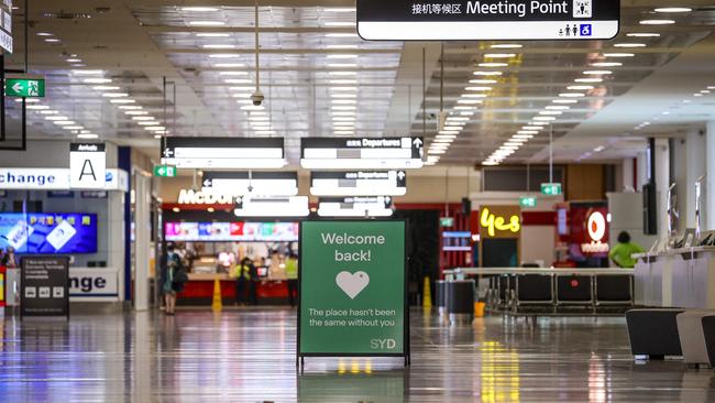 A sign is displayed inside the empty arrivals hall at the international airport in Sydney. Picture: David Gray/AFP