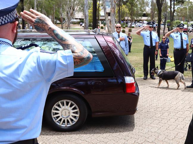 A hearse is saluted at the memorial service with full police honours for constables Rachel McCrow and Matthew Arnold at Brisbane Entertainment Centre. Picture: David Clark