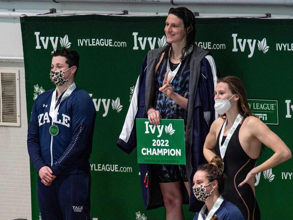 Transgender swimmer Lia Thomas (2nd L) of Penn University and transgender swimmer Iszac Henig (L) of Yale pose with their medals after placing first and second in the 100-yard freestyle swimming race at the 2022 Ivy League Women's Swimming &amp; Diving Championships at Harvard University.