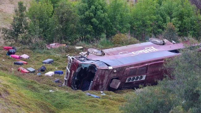 Belongings were strewn around a school bus that rolled down an embankment after a truck collision at Bacchus Marsh. Picture: Brendan Beckett