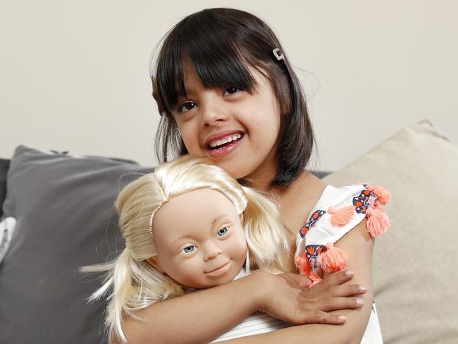 Kmart has launched two new Down Syndrome dolls and disability advocates are delighted by the news as it marks greater representation for people with disabilities. Isabelle Netto, 6, who has Down Syndrome with one of the new dolls at home in Paddington. Picture: Jonathan Ng