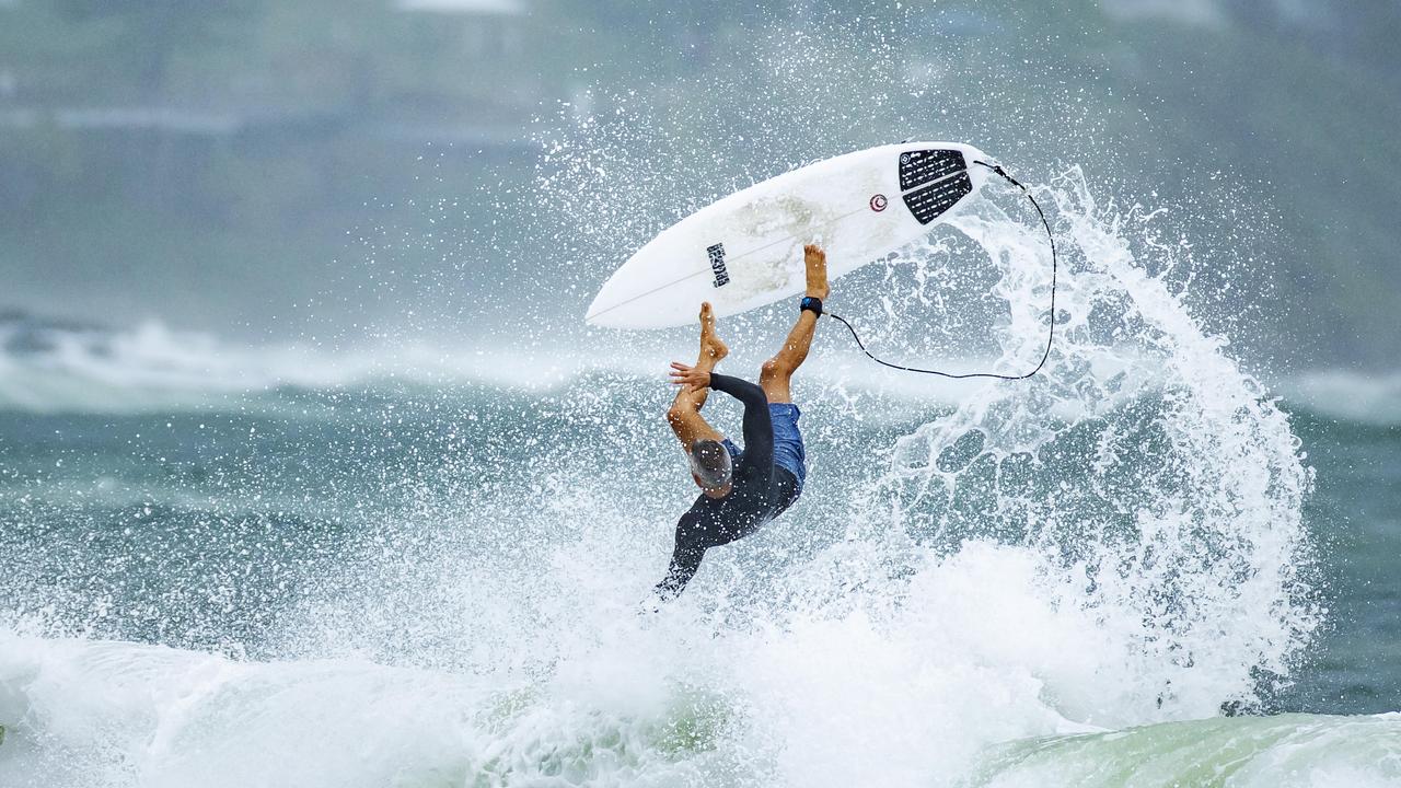 A surfer goes flying in the wild and windy conditions at Mooloolaba as ex Tropical Cyclone Seth crosses the coast. Picture Lachie Millard