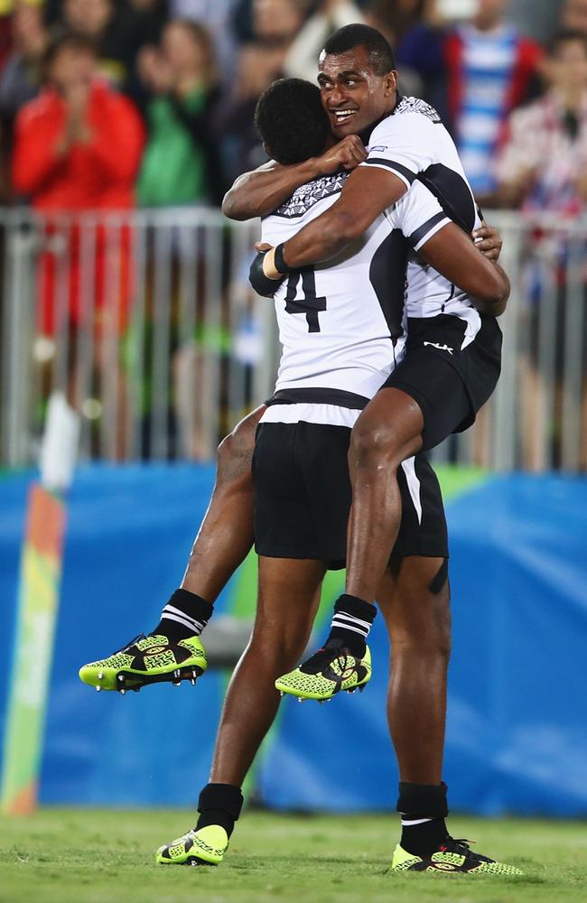 Apisai Domolailai and Viliame Mata of Fiji celebrate as they win gold.