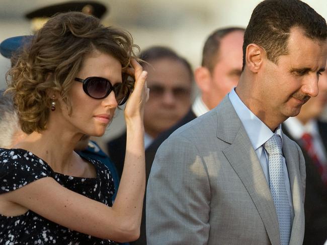 Bashar al-Assad (R) and his wife Asma al-Assad walk upon arrival at the Maiquetia international airport, in Caracas on June 25, 2010. Picture: AFP