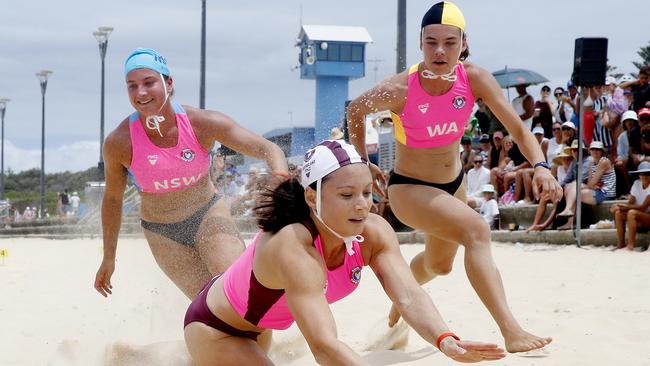 L to R: Alexandra Rampoldi from NSW, EJ Forsyth from Queensland and Imogen Herrington from WA fight it out in the open beach flags.