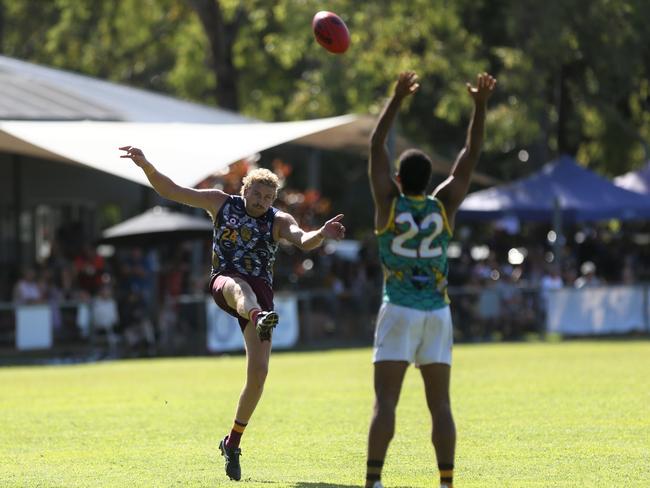 Jackson Calder of the Cairns City Lions kicks a goal. Picture: Harry Murtough