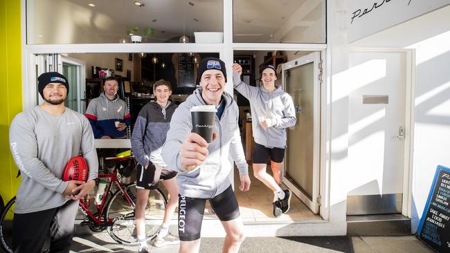 TSL player Sam Siggins with L-R Thor Boscott, Sam Williams, Jaythan Poulson and Aiden Grace. TSL players Sam Siggins and Aiden Grace have started a movement to get people to support their local coffee shops. Picture: RICHARD JUPE