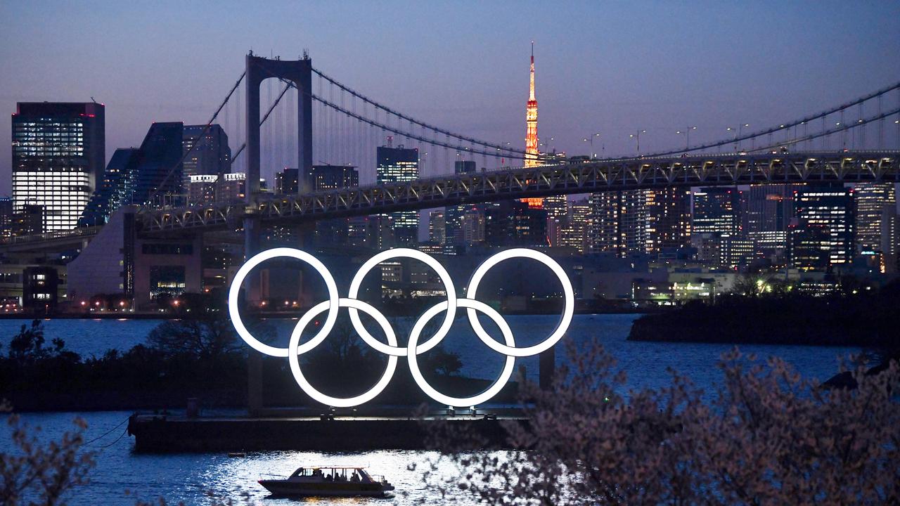 A boat sails past the Tokyo 2020 Olympic Rings on March 25, 2020 in Tokyo, Japan.