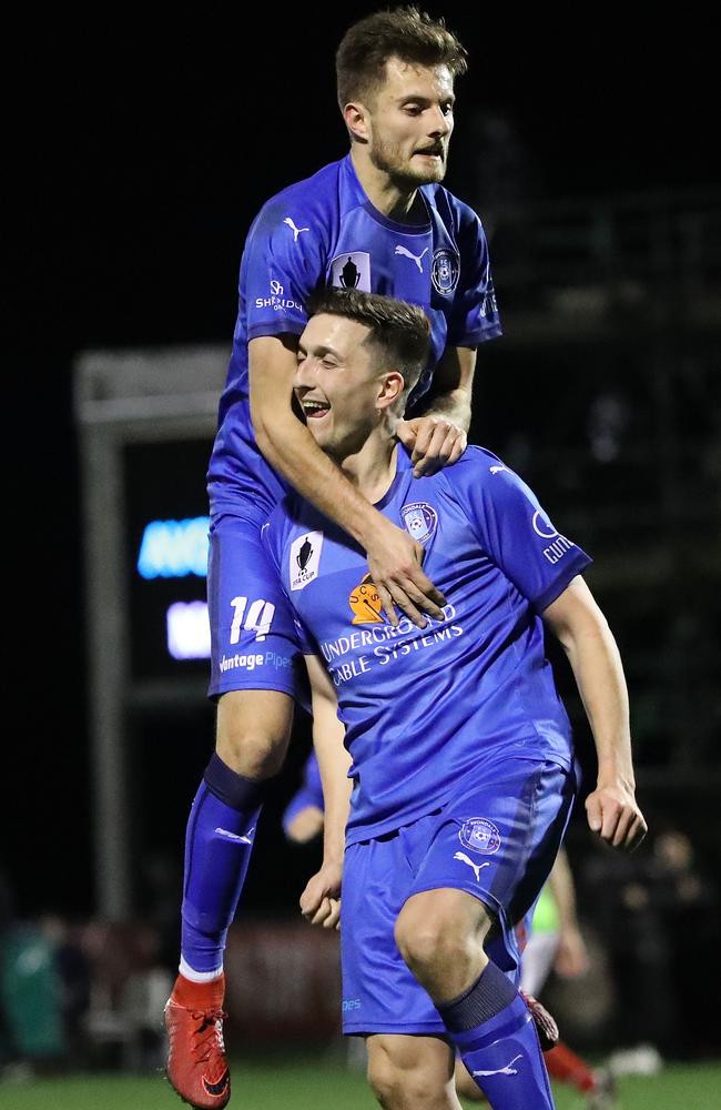 Kaine Sheppard climbs over Liam Boland as the strike pair celebrate his goal during the FFA Cup Round of 32. Picture: Getty Images.