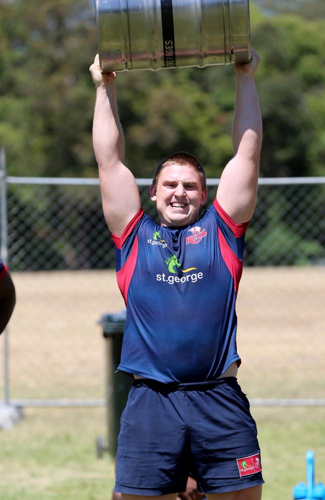 Markus Vanzati just lifting a keg (full of XXXX?) over his head at Reds training.